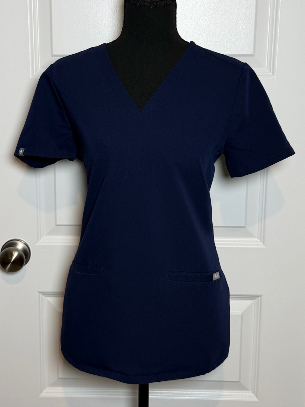 FIGS Casma Three-Pocket Scrub Top in classic Navy blue.